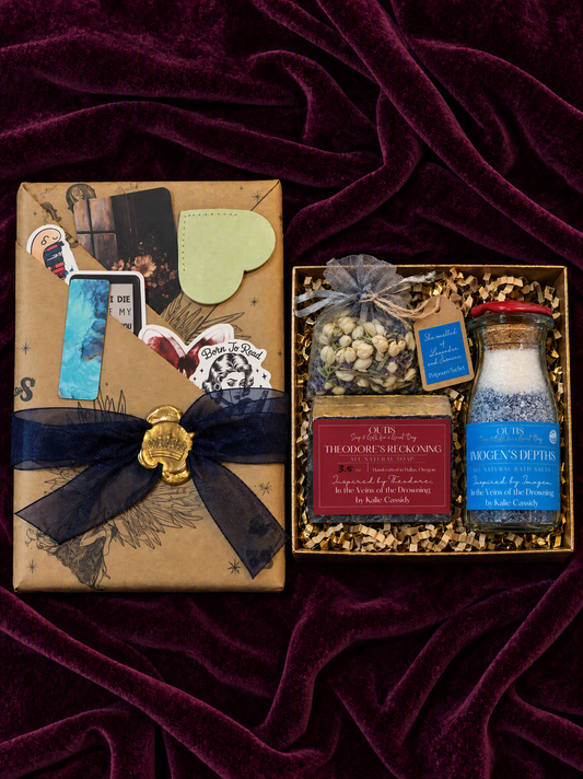 The wrapped book and bath collection laid on plum velvet